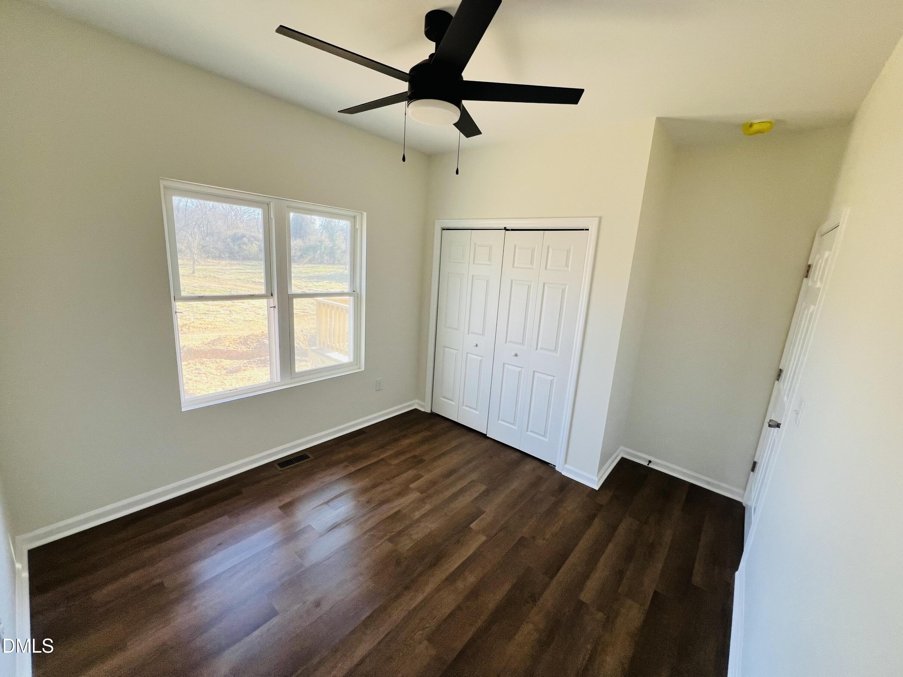 500 Jones Lester Road Roxboro, NC 27574 - Photo 5 of 17 a view of an empty room with wooden floor and a window