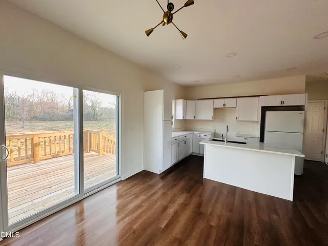 a kitchen with a refrigerator a sink and a large window