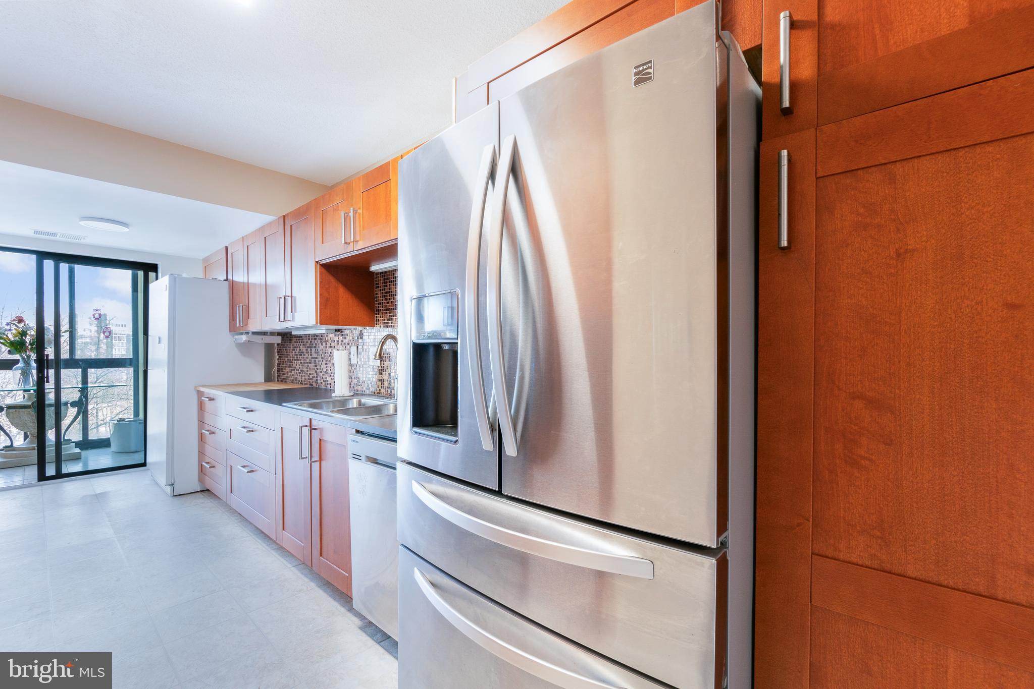 15115 Interlachen Drive, Unit 3607 Silver Spring, MD 20906 - Photo 12 of 37 a kitchen with stainless steel appliances a refrigerator and a stove top oven