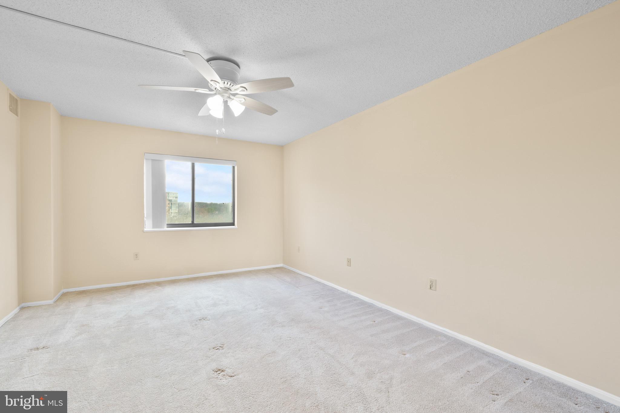 15115 Interlachen Drive, Unit 3607 Silver Spring, MD 20906 - Photo 14 of 37 an empty room with a window and a fan
