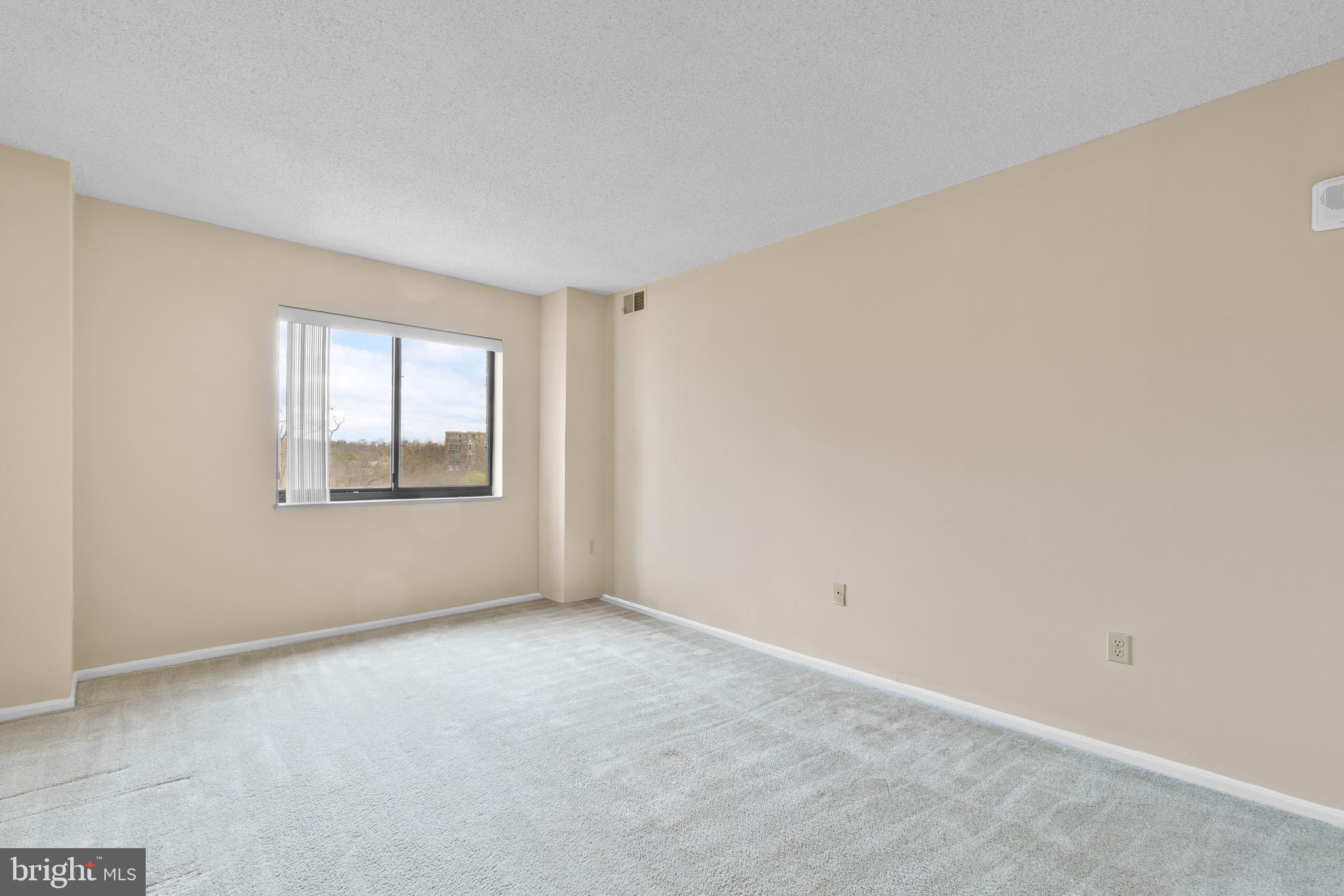 15115 Interlachen Drive, Unit 3607 Silver Spring, MD 20906 - Photo 15 of 37 a view of an empty room with a window