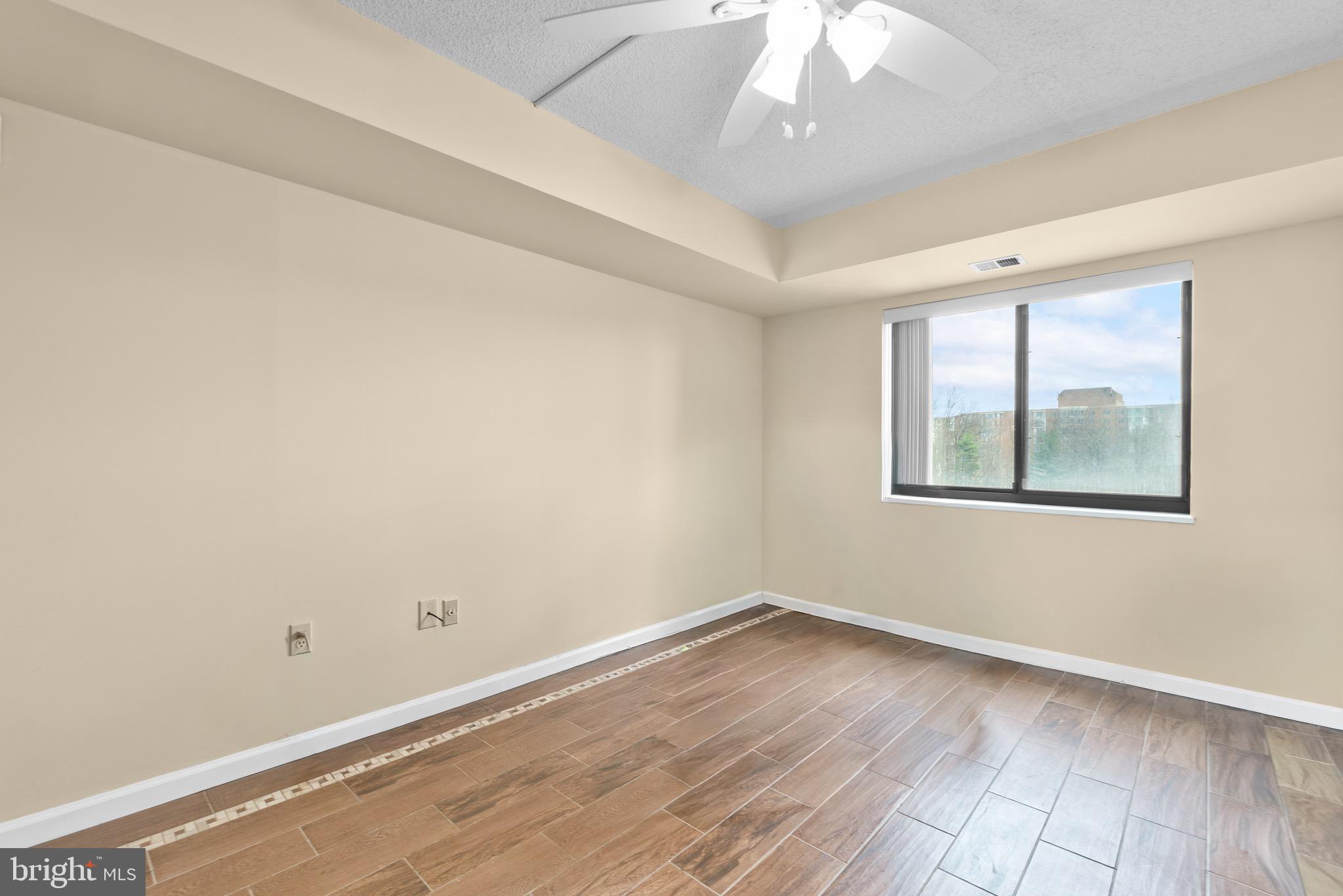 15115 Interlachen Drive, Unit 3607 Silver Spring, MD 20906 - Photo 16 of 37 wooden floor in an empty room with a window