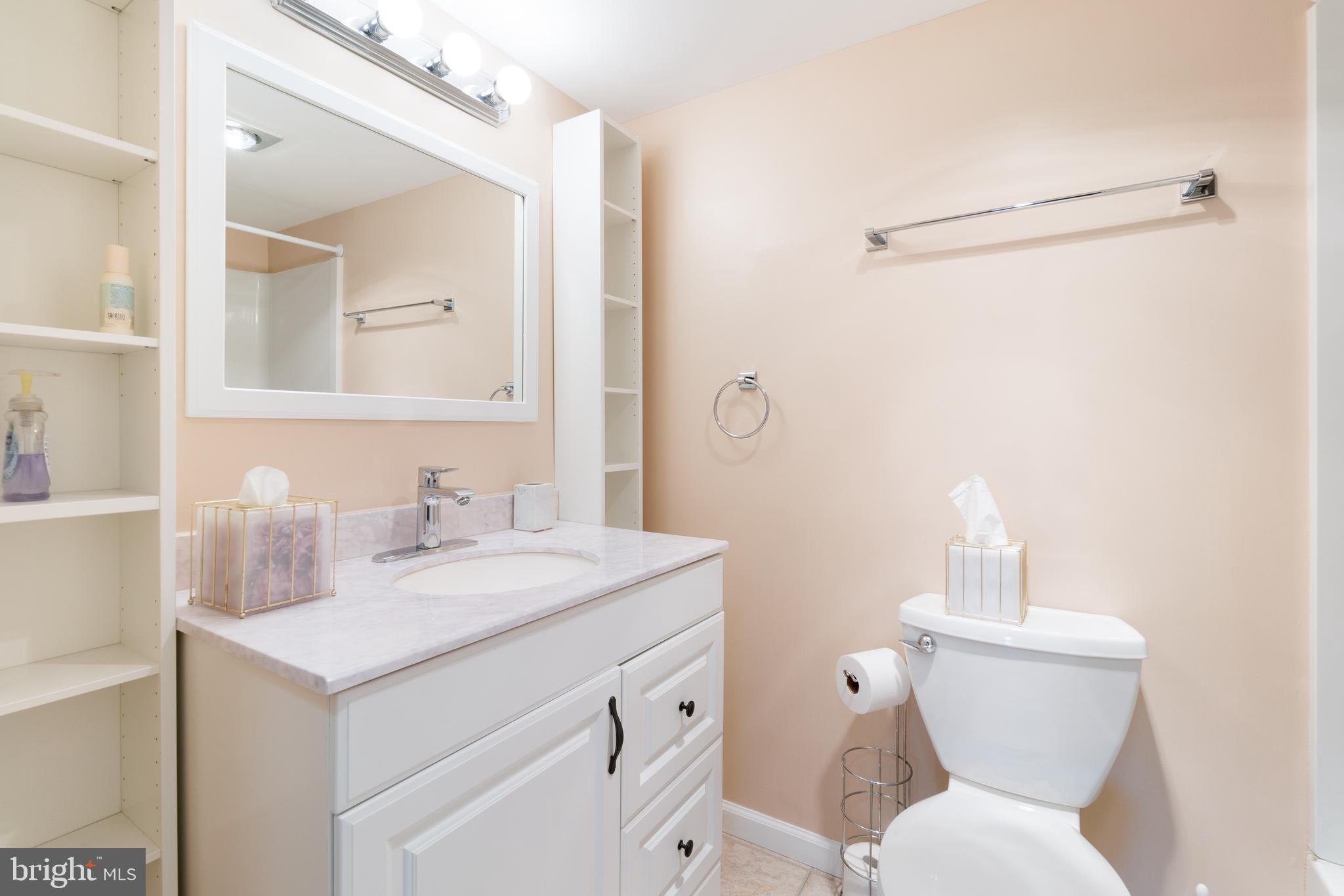 15115 Interlachen Drive, Unit 3607 Silver Spring, MD 20906 - Photo 23 of 37 a bathroom with a toilet sink and mirror