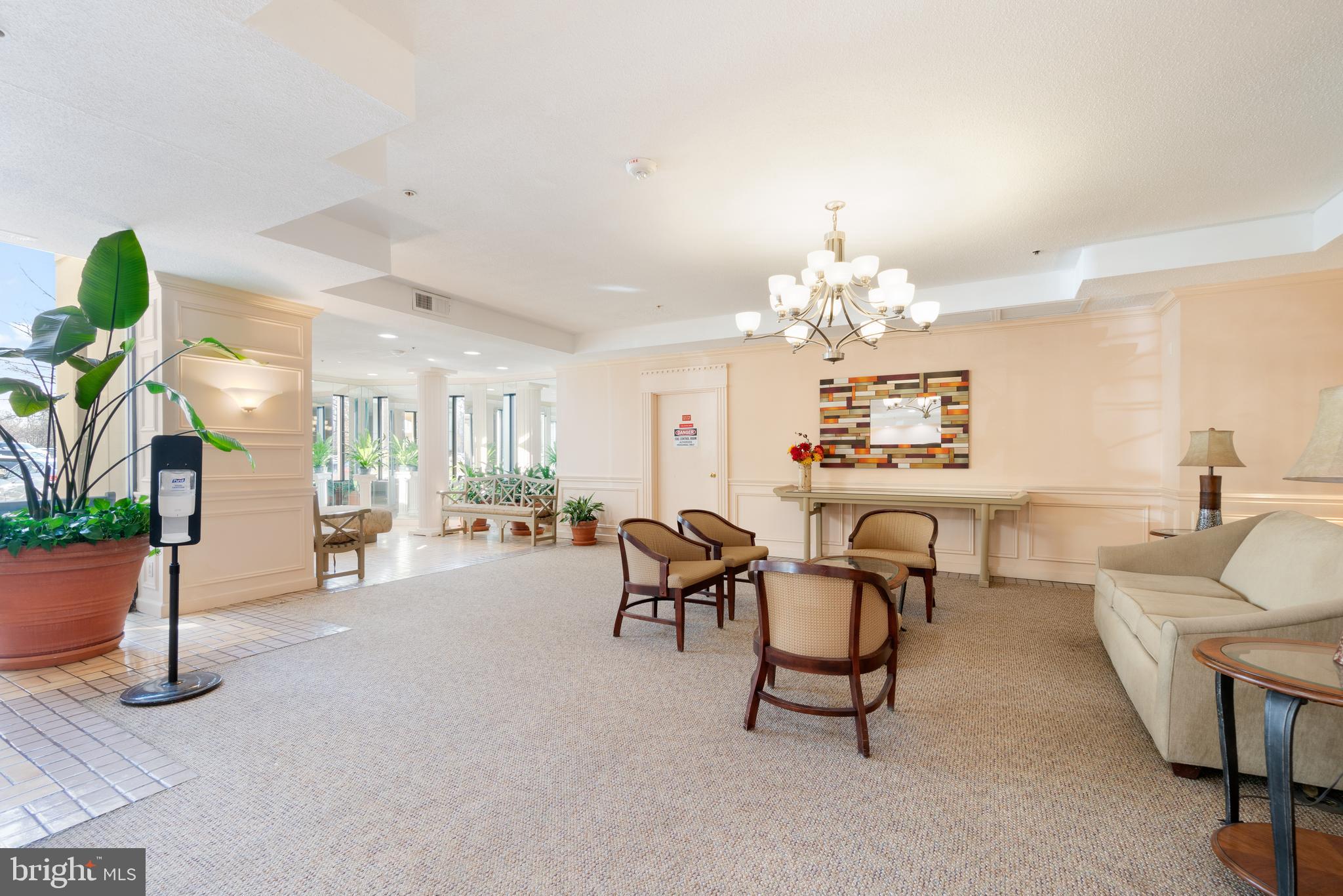 15115 Interlachen Drive, Unit 3607 Silver Spring, MD 20906 - Photo 25 of 37 a living room with furniture a chandelier and a dining table