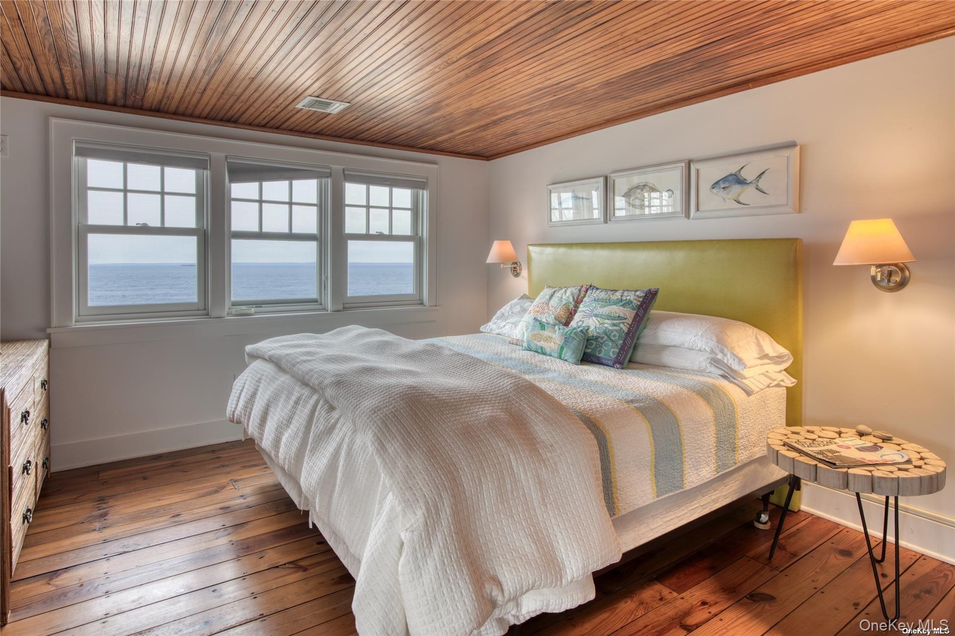 2100 Youngs Road Orient, NY 11957 - Photo 11 of 22 a bedroom with a bed and wooden floor