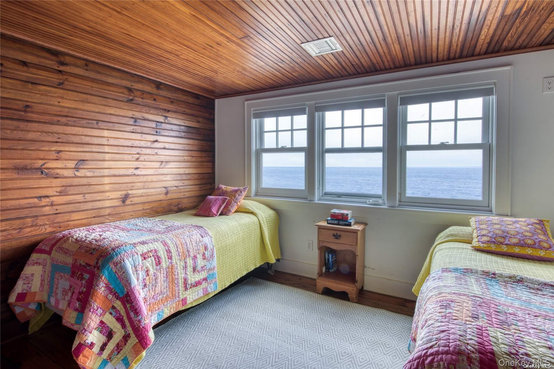2100 Youngs Road Orient, NY 11957 - Photo 14 of 22 a bedroom with a bed and a large window