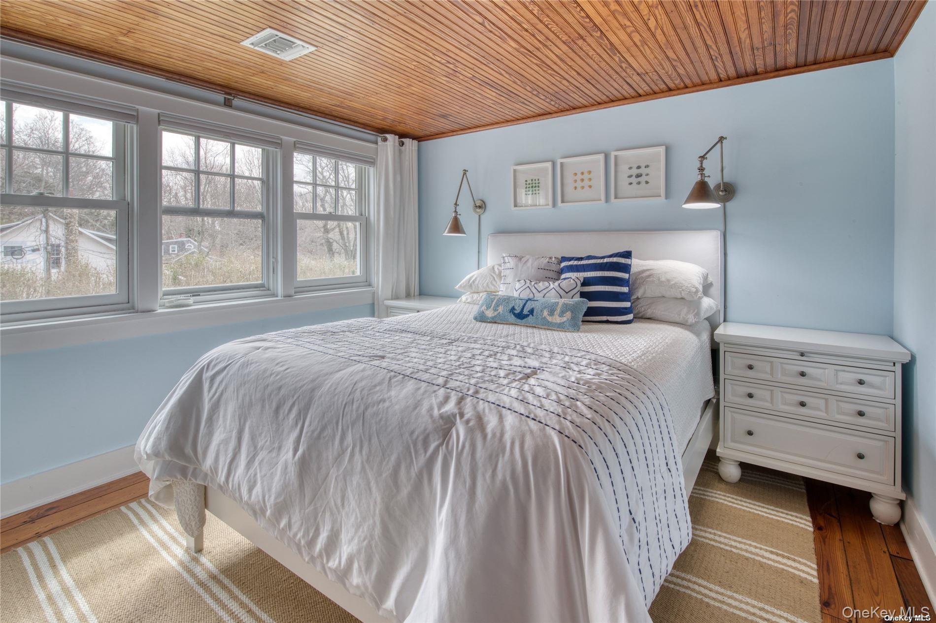 2100 Youngs Road Orient, NY 11957 - Photo 16 of 22 a bedroom with a bed and a dresser
