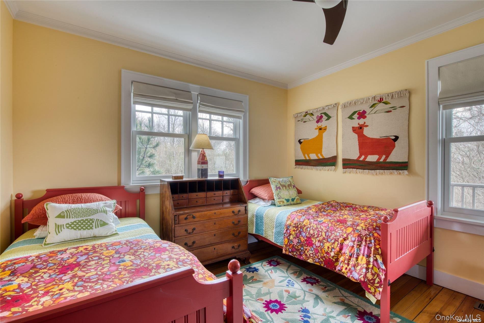 2100 Youngs Road Orient, NY 11957 - Photo 17 of 22 a bedroom with a bed and wooden floor