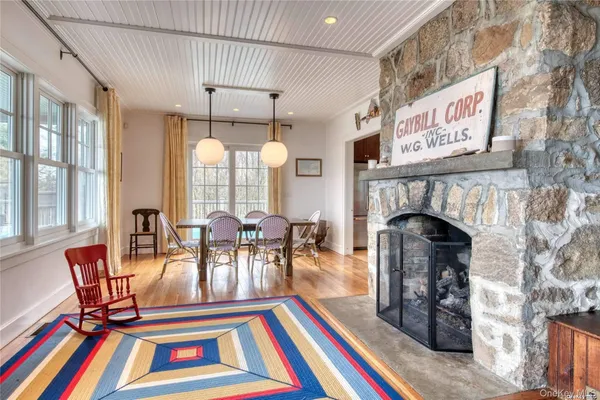 a view of a dining room with furniture and a fireplace