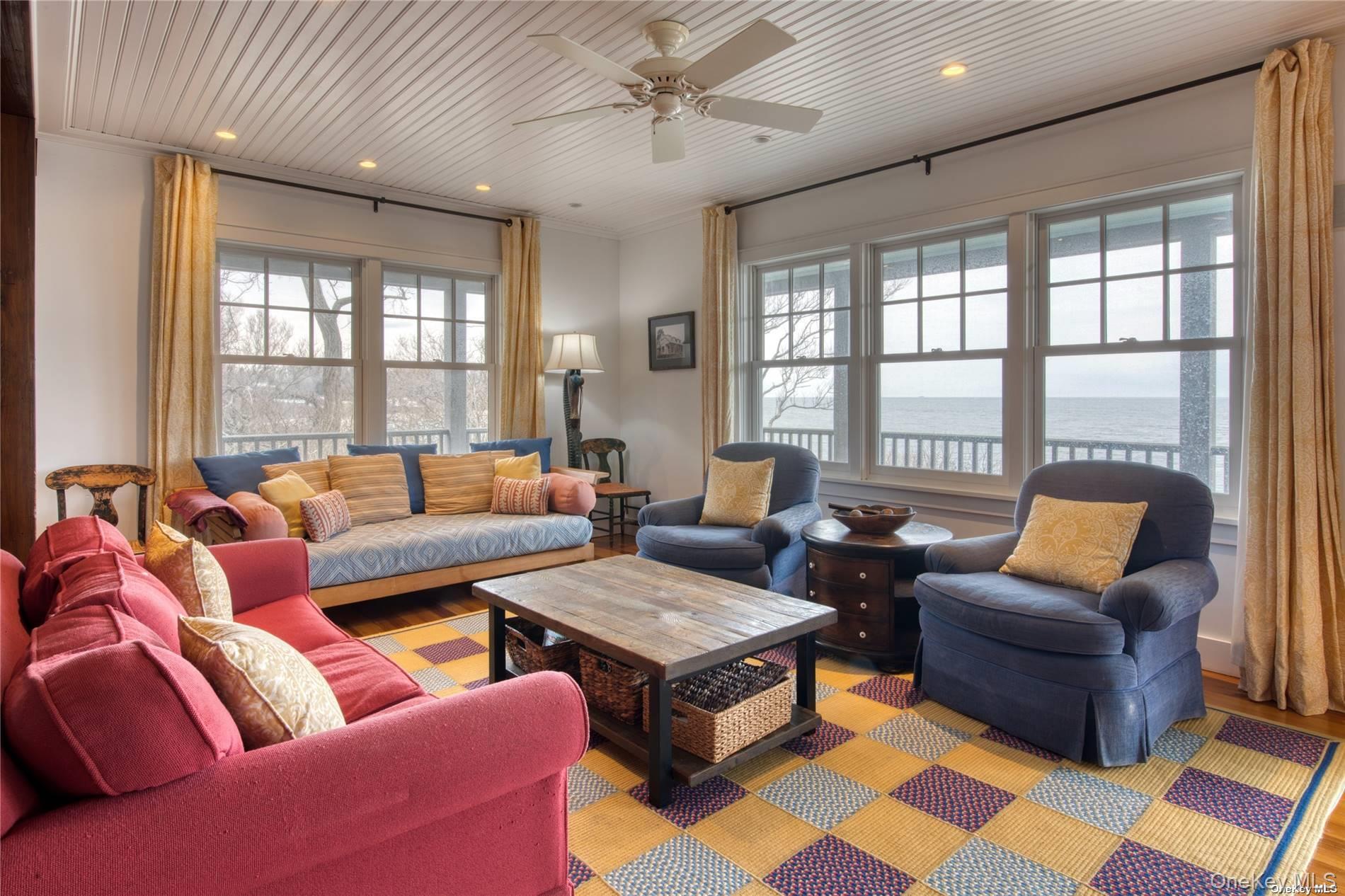 2100 Youngs Road Orient, NY 11957 - Photo 9 of 22 a living room with furniture a large window and a rug