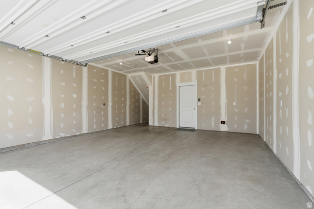 1173 West 1870 South Logan, UT 84321 - Photo 22 of 33 Spacious garage featuring a concrete floor, unpainted drywall, and an overhead garage door mechanism