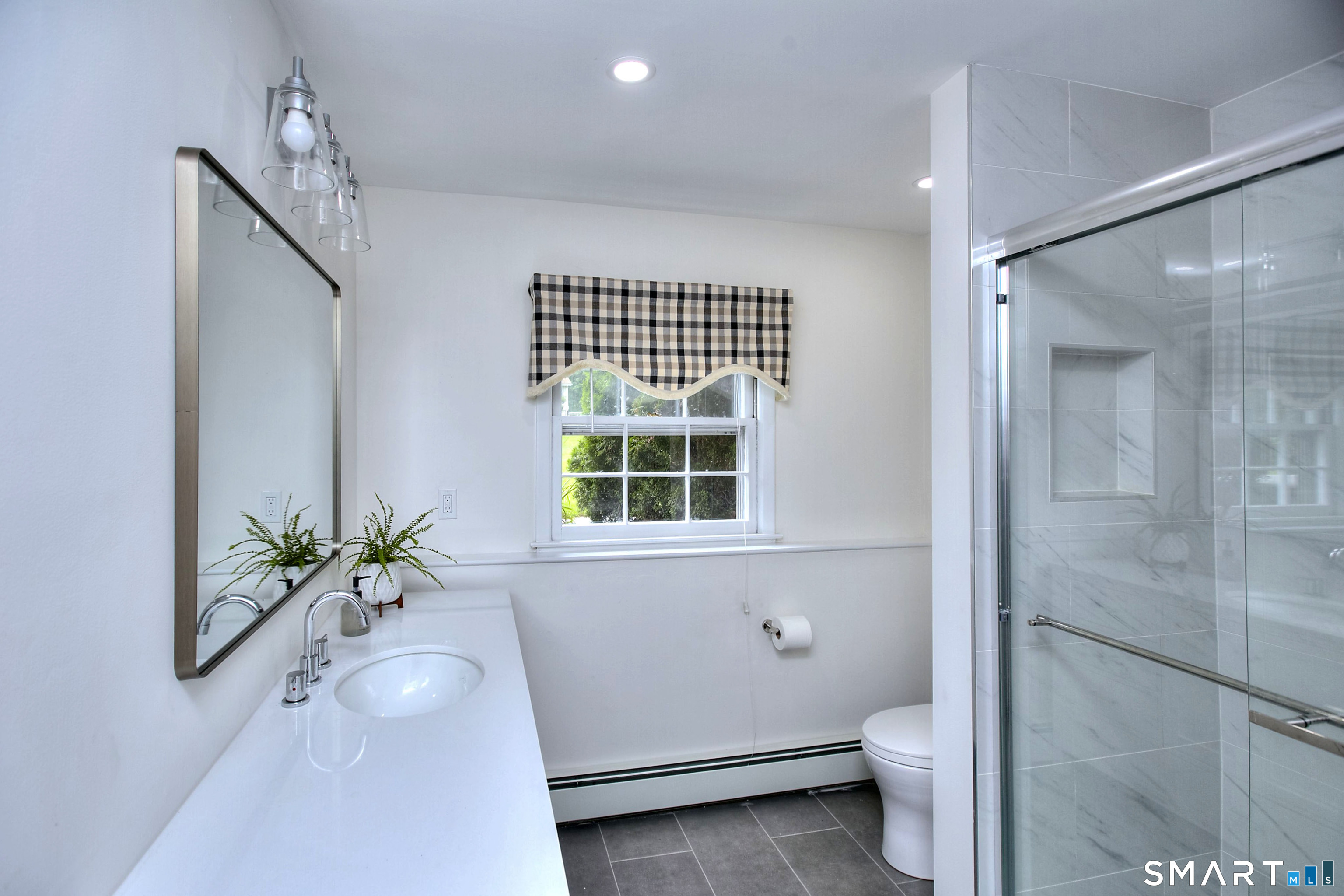 324 Ridge Road Orange, CT 06477 - Photo 22 of 38 a bathroom with a granite countertop sink a toilet and shower