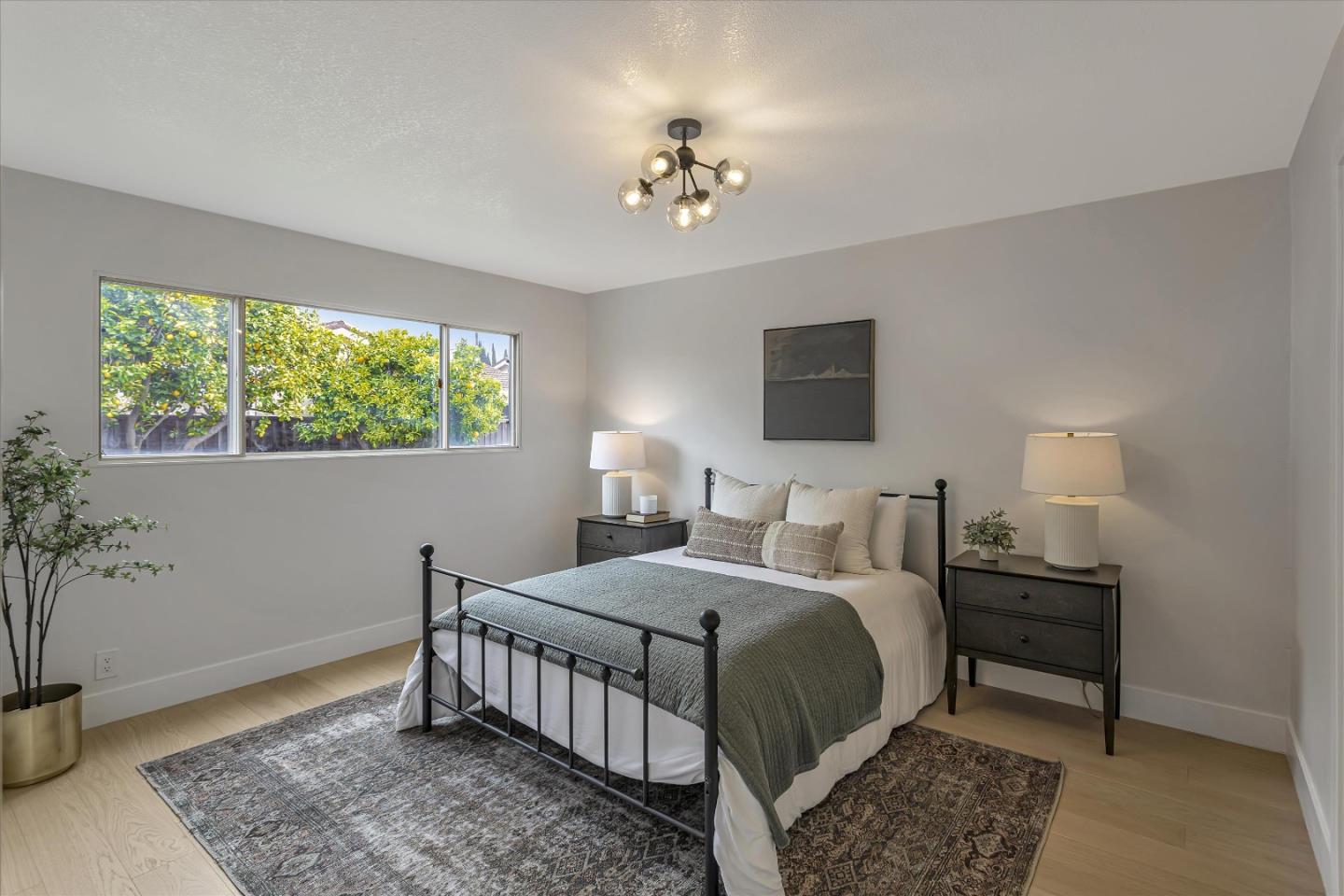 2860 Encinitas Court San Jose, CA 95132 - Photo 23 of 45 a bedroom with a bed and a chandelier