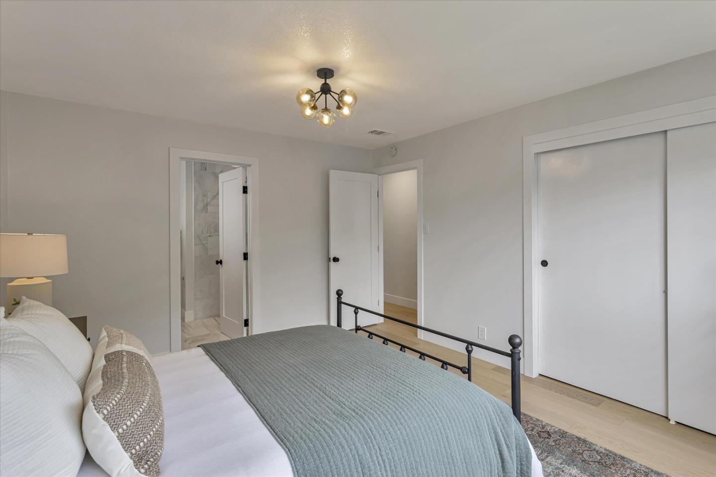 2860 Encinitas Court San Jose, CA 95132 - Photo 24 of 45 a bedroom with a bed and a chandelier