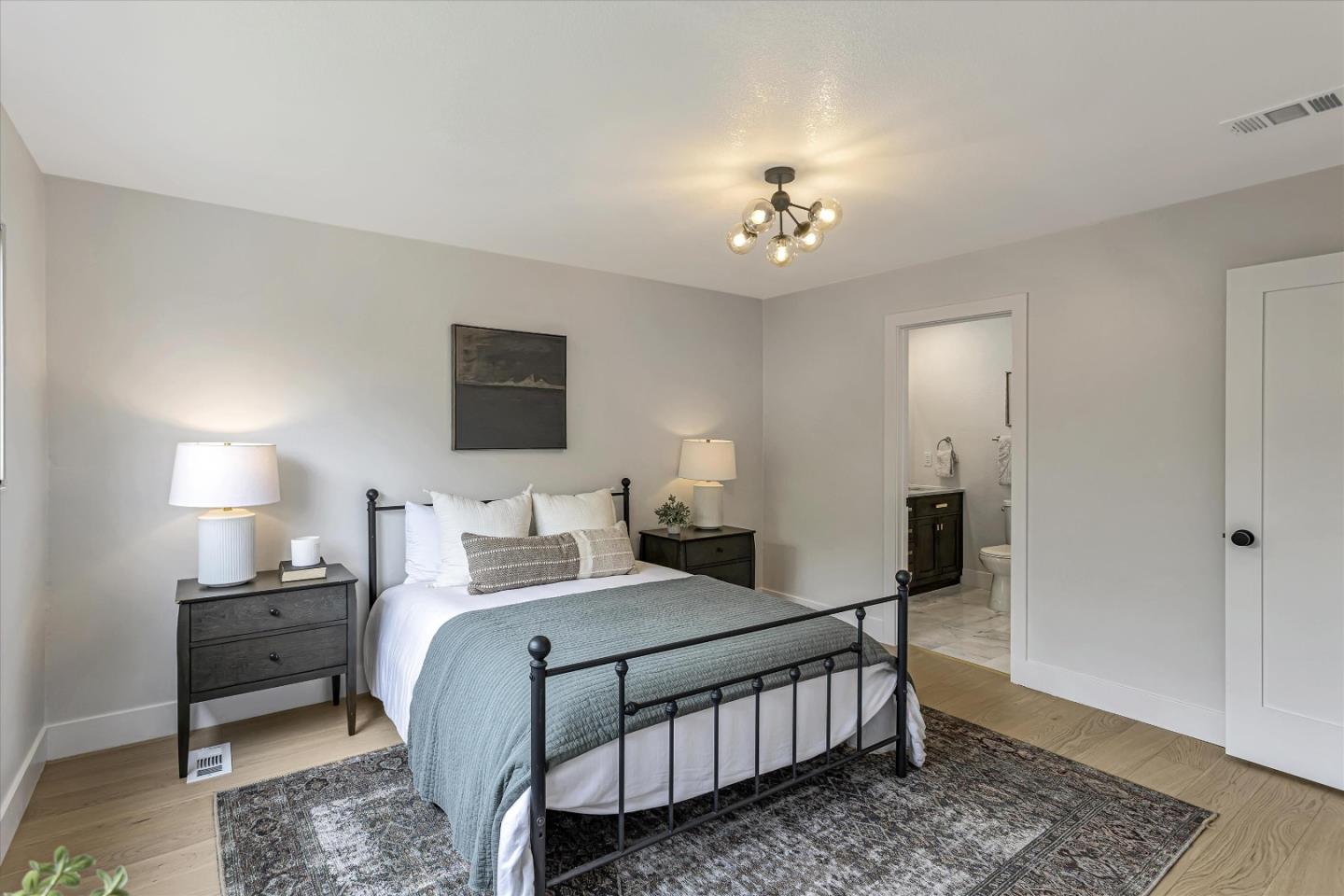 2860 Encinitas Court San Jose, CA 95132 - Photo 25 of 45 a bedroom with a bed and a chandelier