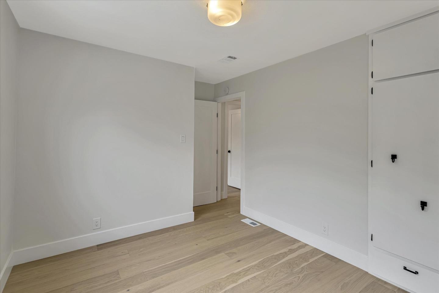 2860 Encinitas Court San Jose, CA 95132 - Photo 29 of 45 a view of an empty room with wooden floor and a window