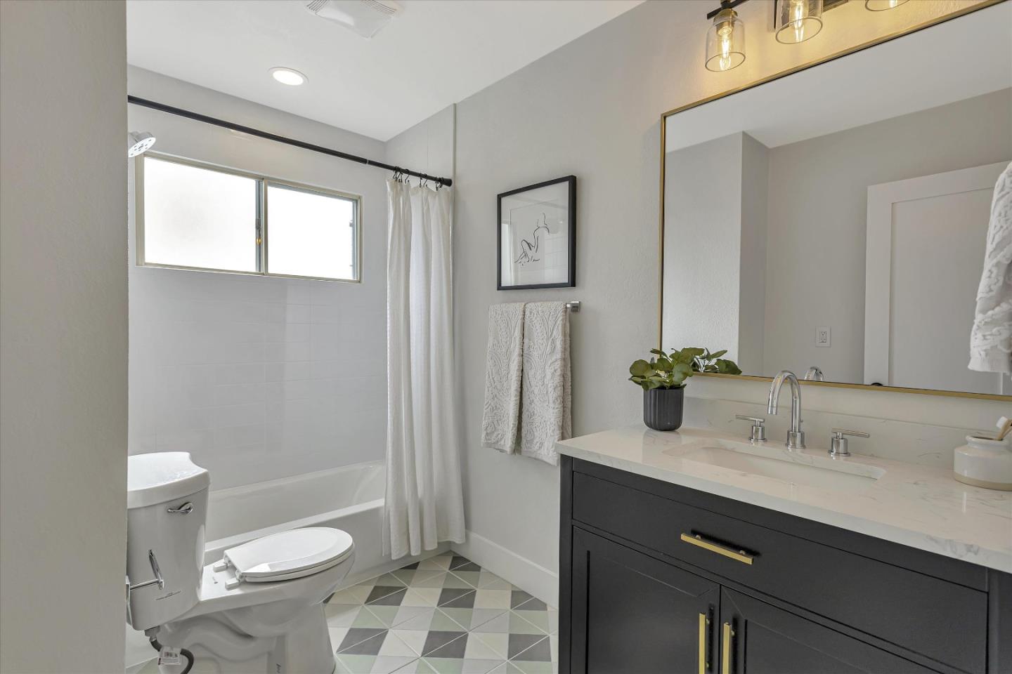 2860 Encinitas Court San Jose, CA 95132 - Photo 30 of 45 a bathroom with a sink a toilet a shower and a mirror