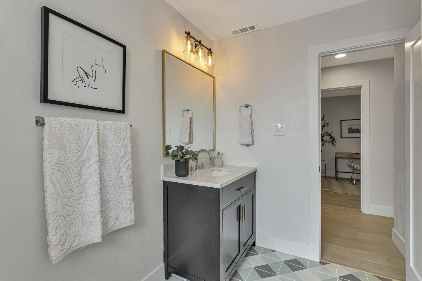 2860 Encinitas Court San Jose, CA 95132 - Photo 31 of 45 a bathroom with a sink mirror and a shower