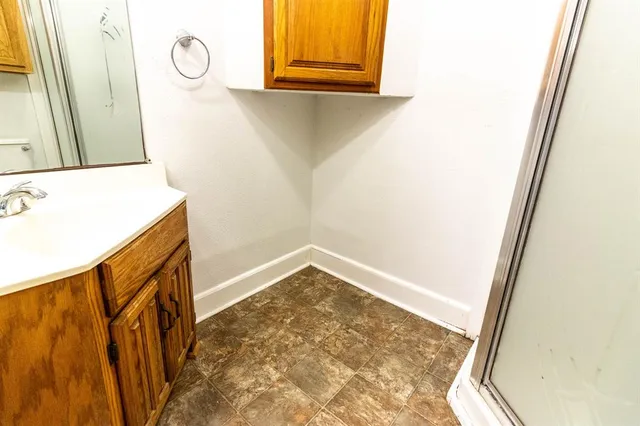 a view of a bathroom with a sink and a mirror