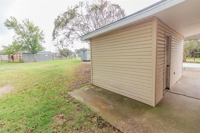 a view of a backyard with large trees