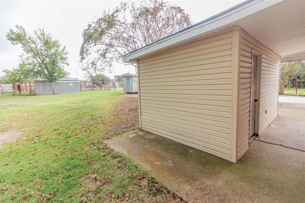 801 South Sutton Street Mabank, TX 75147 - Photo 19 of 26 a view of a backyard with large trees