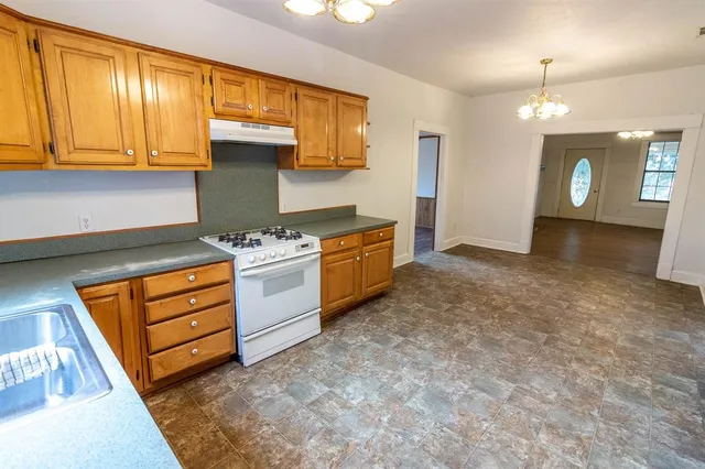 a kitchen with stainless steel appliances granite countertop a stove and a sink