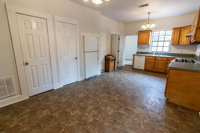 a kitchen with granite countertop a sink cabinets and window