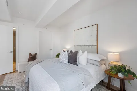 a bedroom with a bed and a lamp