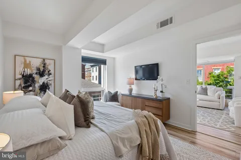 a bedroom with a bed and a flat screen tv