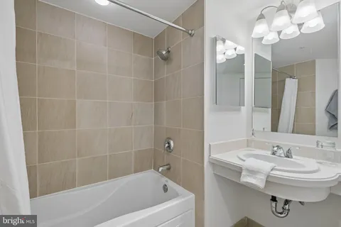 a bathroom with a bathtub a sink a toilet and a mirror