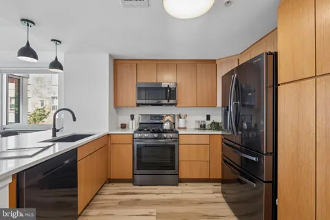 a kitchen with a sink appliances and cabinets