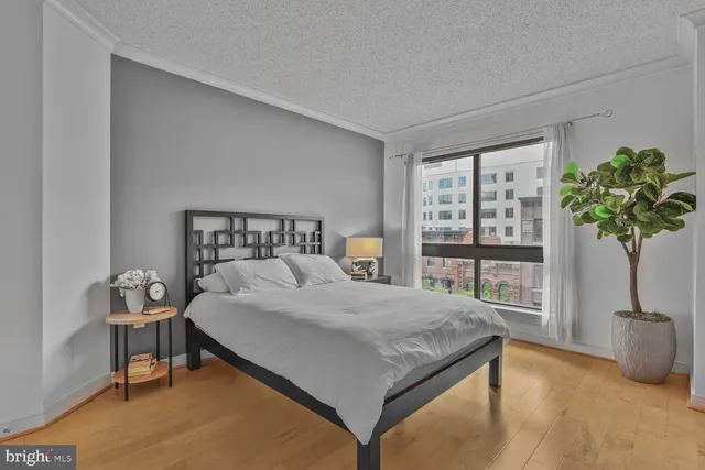 a bedroom with a bed and a potted plant