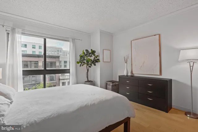 a bedroom with a bed and a dresser