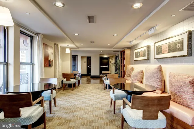 a living room with fireplace furniture and a large window