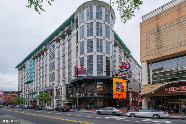 a view of a tall building on a street