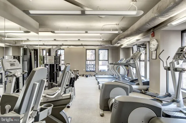 a living room with furniture and large windows