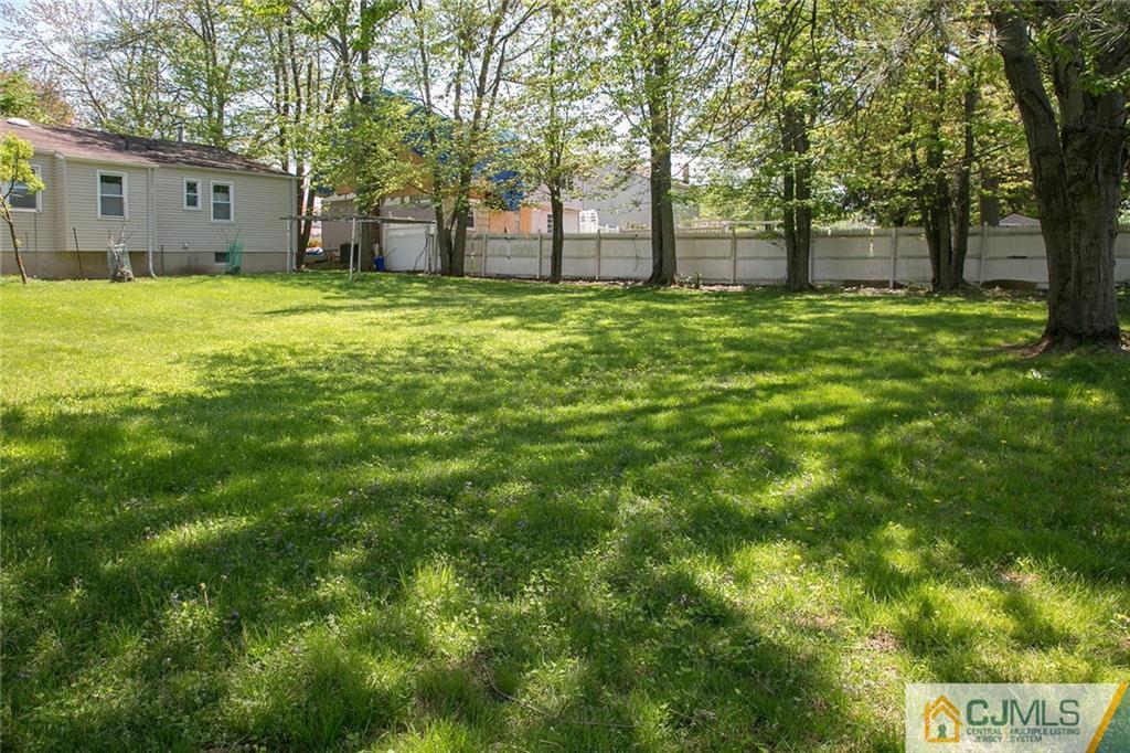 7 Roxy Avenue Edison, NJ 08820 - Photo 22 of 24 a view of a yard with a house and large trees