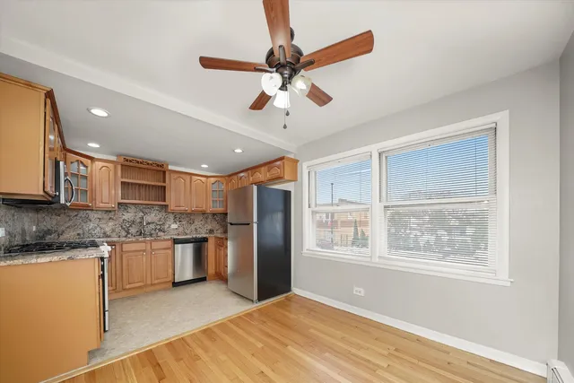 a kitchen with stainless steel appliances granite countertop a refrigerator and a sink
