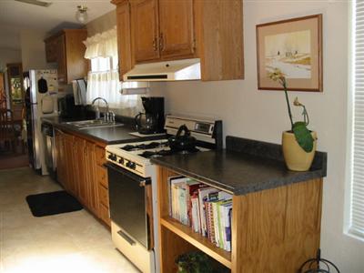 88 Yosemite Road, Unit 88 San Rafael, CA 94903 - Photo 2 of 11 a kitchen with stainless steel appliances granite countertop a sink a stove and a wooden cabinets