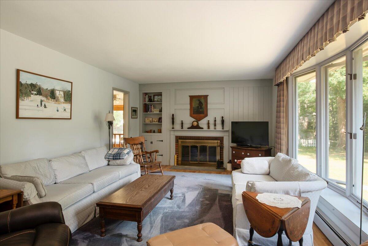 169-173 Old Post Road Centerville, MA 02632 - Photo 24 of 50 a living room with furniture a flat screen tv and a fireplace