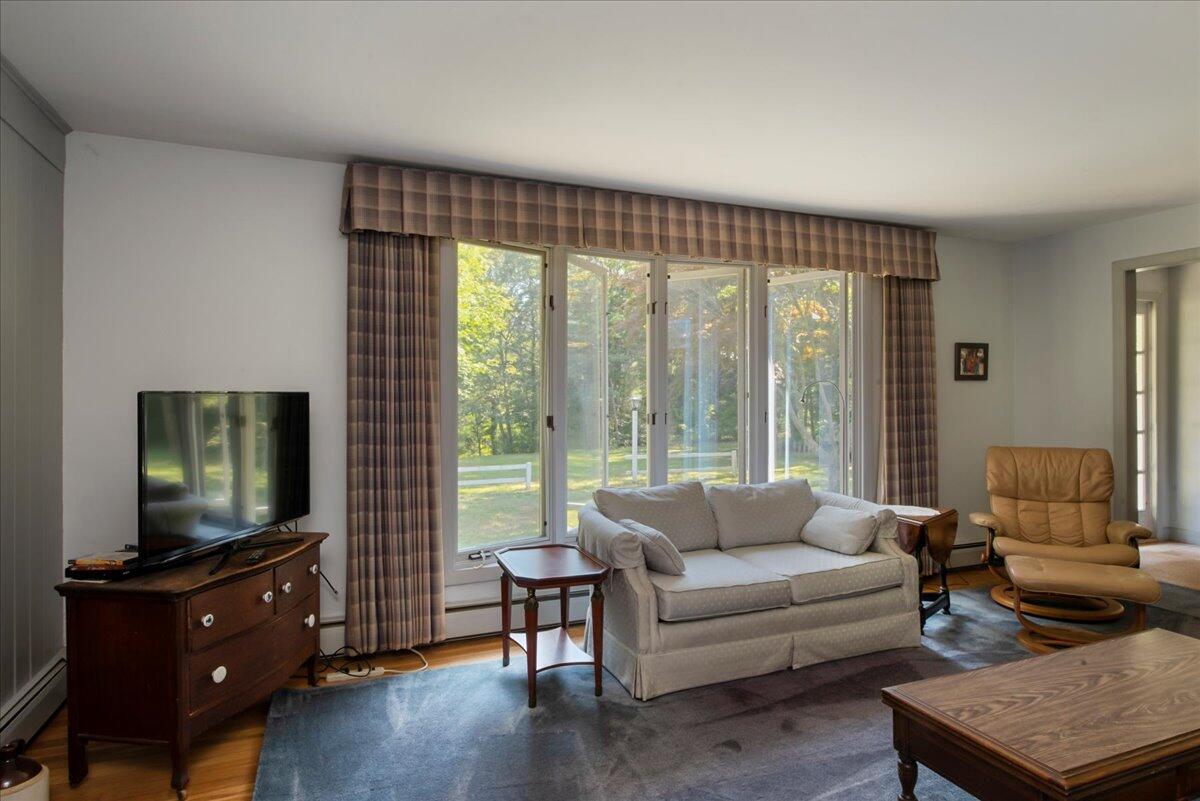169-173 Old Post Road Centerville, MA 02632 - Photo 25 of 50 a living room with furniture and a flat screen tv