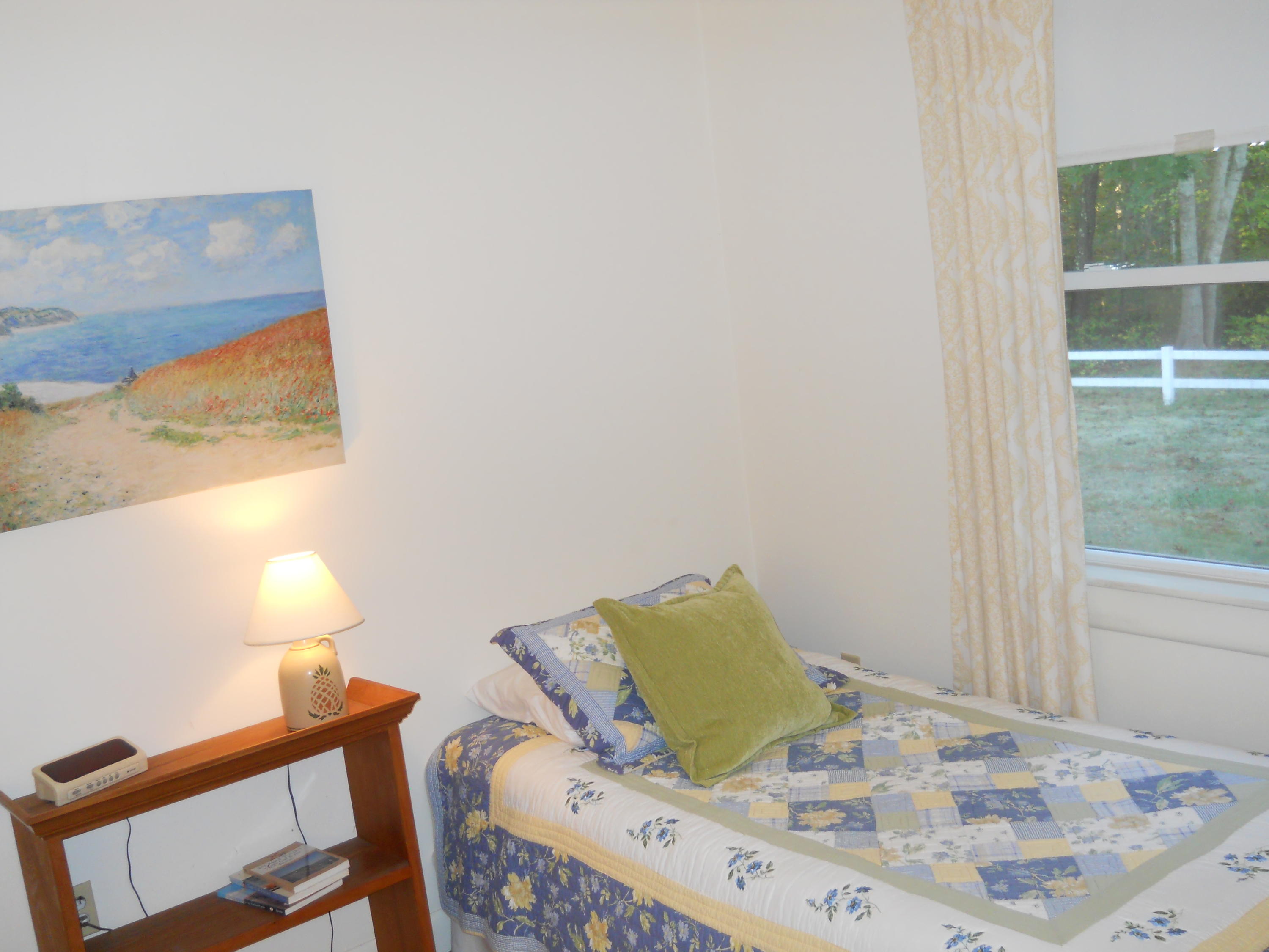 169-173 Old Post Road Centerville, MA 02632 - Photo 33 of 50 a bed sitting in a bedroom next to a window