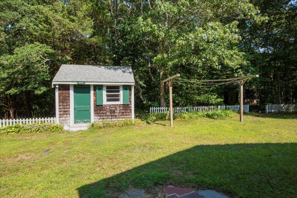 169-173 Old Post Road Centerville, MA 02632 - Photo 8 of 50 a front view of a house with a yard table and chairs