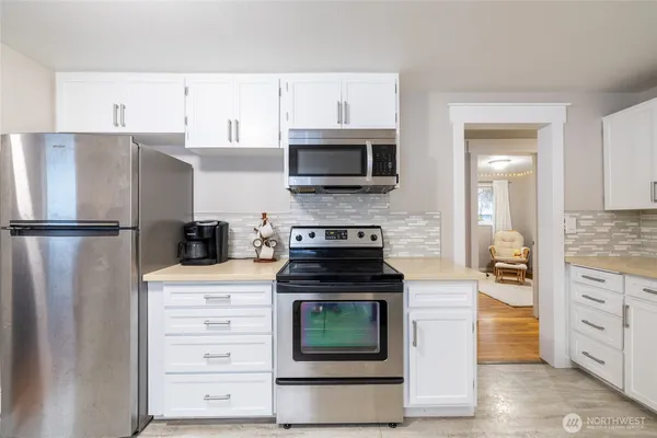 a kitchen with stainless steel appliances granite countertop a stove and a refrigerator