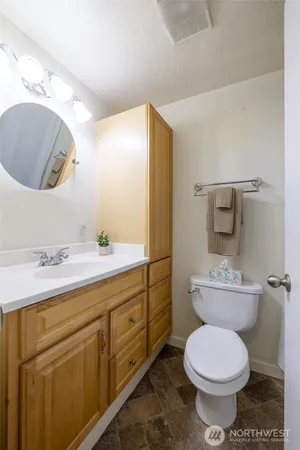 a bathroom with a toilet sink and mirror