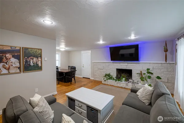 a living room with furniture a fireplace and a flat screen tv