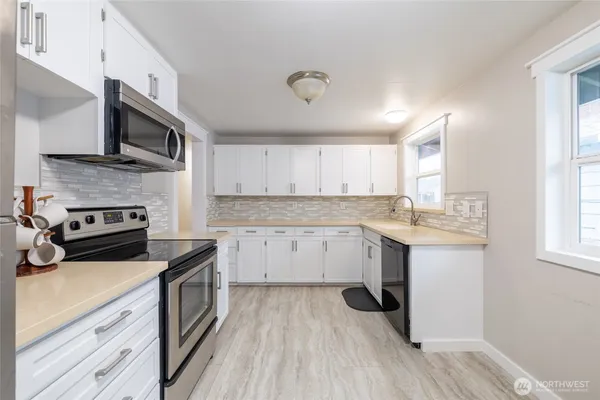 a kitchen with a sink stove and microwave
