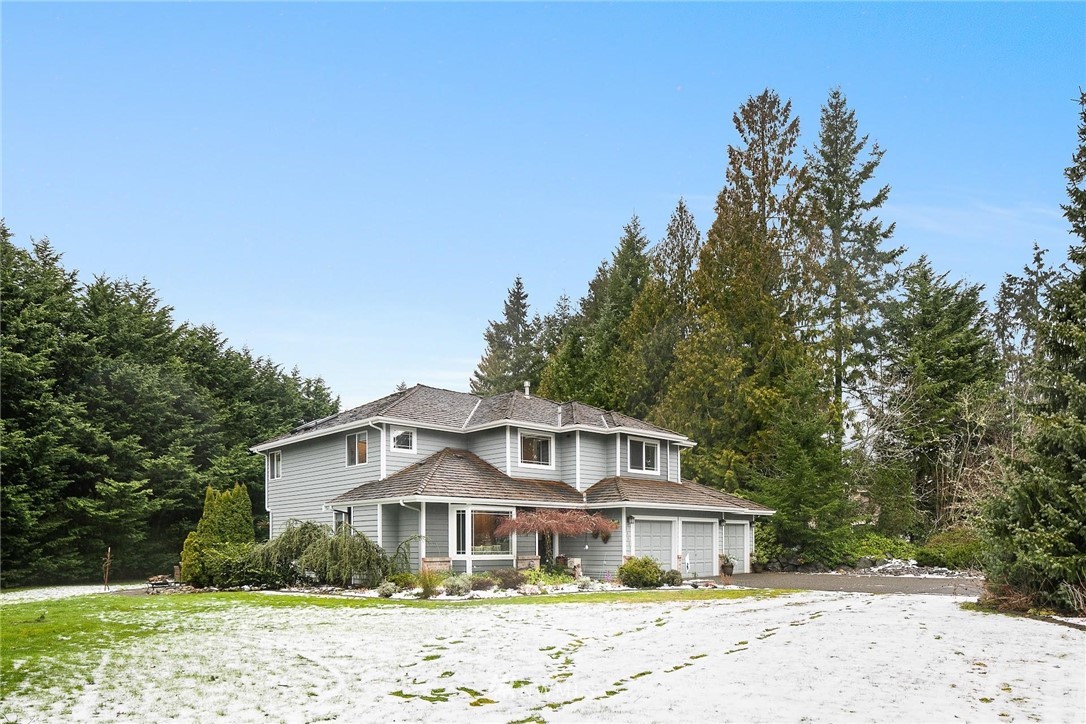 23809 Southeast 243rd Street Maple Valley, WA 98038 - Photo 2 of 40 a front view of a house with a yard