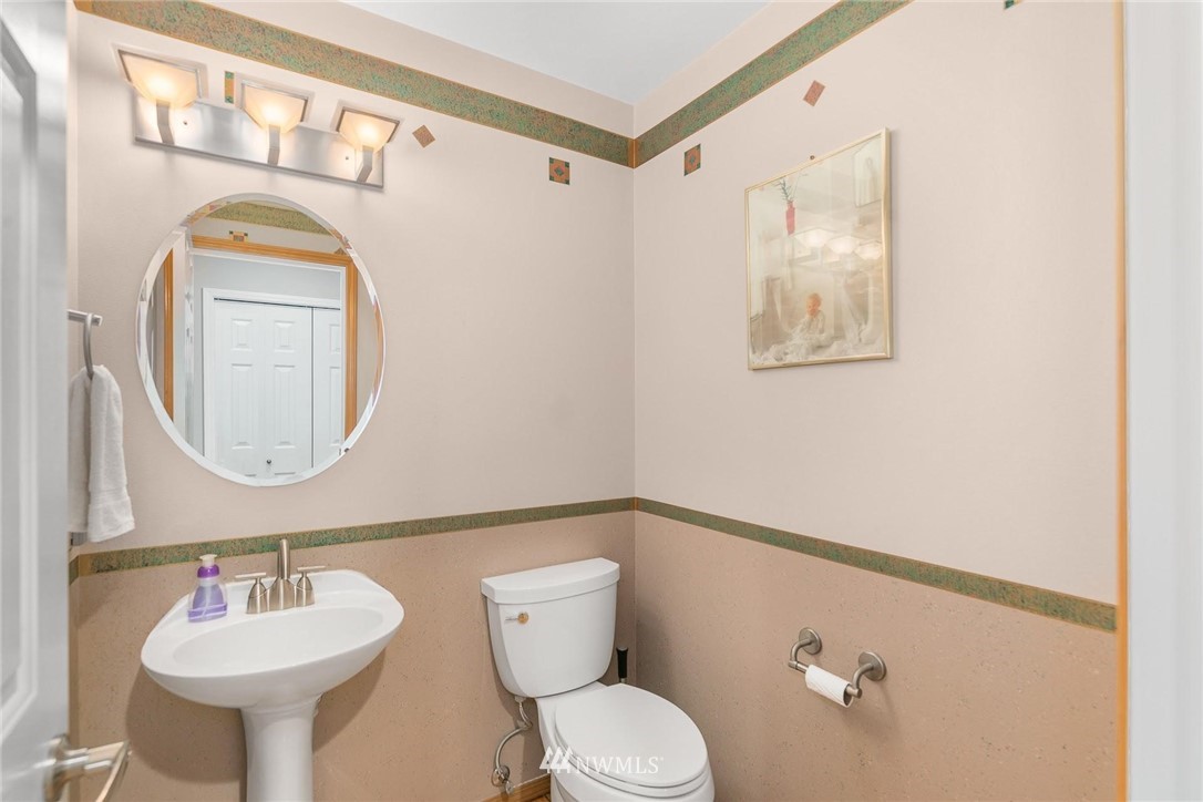 23809 Southeast 243rd Street Maple Valley, WA 98038 - Photo 14 of 40 a bathroom with a toilet sink and mirror