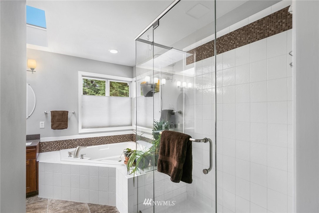 23809 Southeast 243rd Street Maple Valley, WA 98038 - Photo 21 of 40 a bathroom with a tub sink and mirror